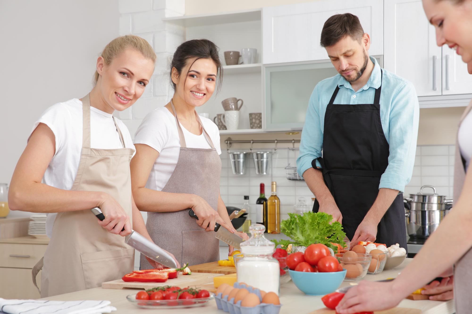 Students cooking together in warm kitchen